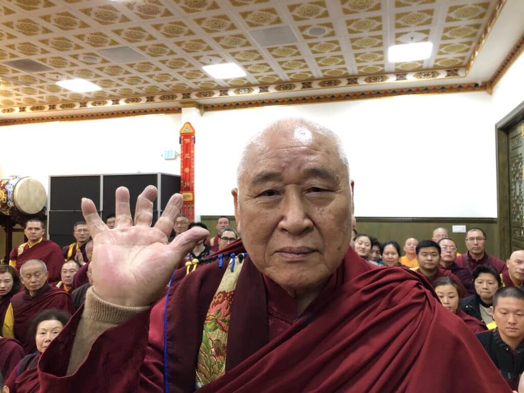 年近90歲的聖僧開初教尊用他三根手指頭已骨節折斷變形的右手,單手拿起了200磅金剛杵上基座,展顯了其上超十六段的聖力,遠超亞洲第一大力士,驚駭世人。 (攝影:楊慧君)